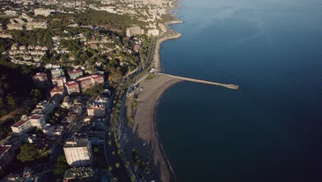 High-altitude-aerial-view-during-sunshine-day-over-Mediterranean-coast-at-Malaga,-Spain