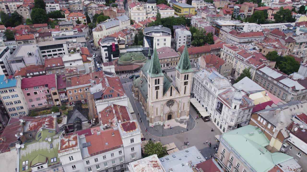 Aerial: Sarajevo's Sacred Heart Cathedral amidst urban landscape