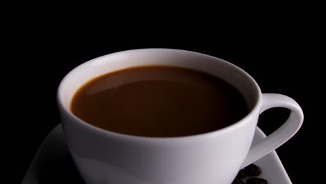 white coffee cup with coffee beans