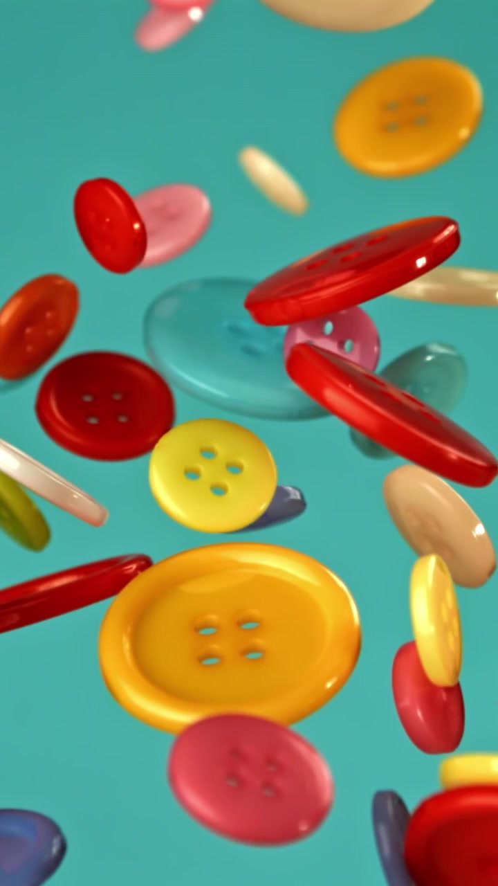 Vibrant Buttons Falling in Slow Motion on Teal Background