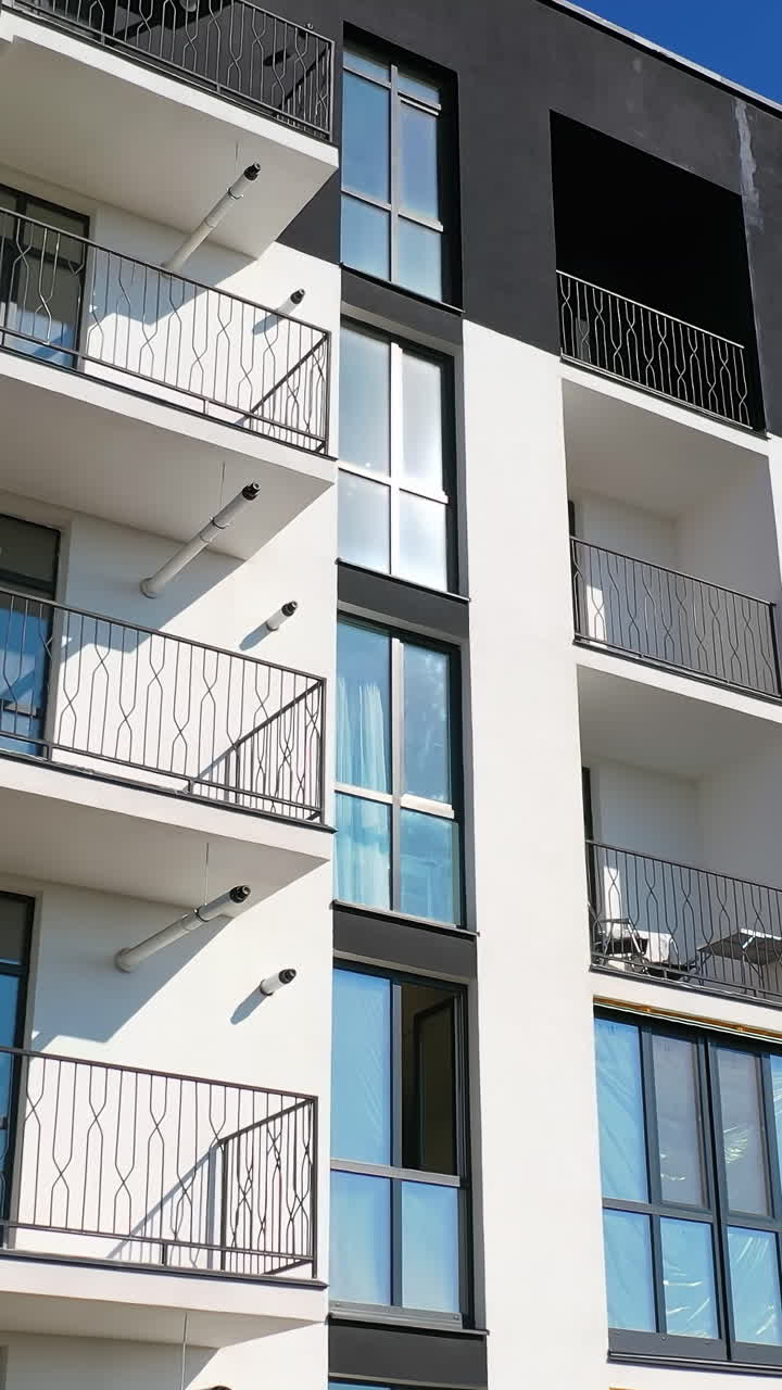 Boligområde med høje lejlighedsbygninger. Luftfoto af høj beboelseslejlighedsbygning med mange vinduer og altaner.