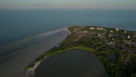 holbox island in mexico showing beaches, greenery, and buildings at sunrise, aerial view