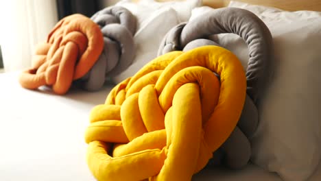 knotted pillows on a bed