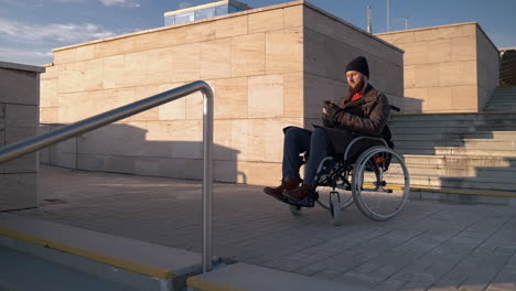 man in wheelchair on stairs