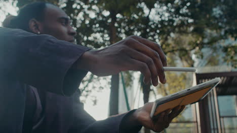 man using tablet outdoors