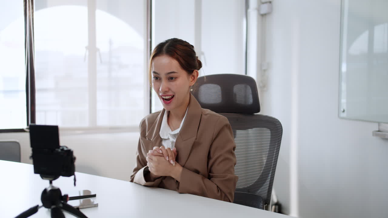 A professional woman engages in a virtual meeting demonstrating effective communication in a modern office setting.