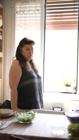 woman looking out a kitchen window