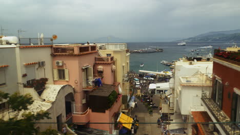 looking out the train window in capri, italy as the city center and the daily activity passes by in the distance