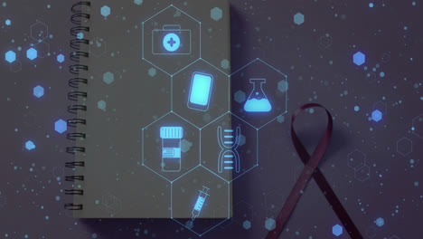 animation of medical icons over notebook and ribbon