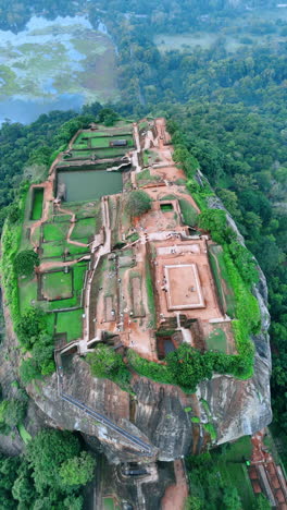 ruins of sigiriya fortress on the huge mountain in sri lanka. top view. beautiful scenery of lush greenery at backdrop. vertical video.