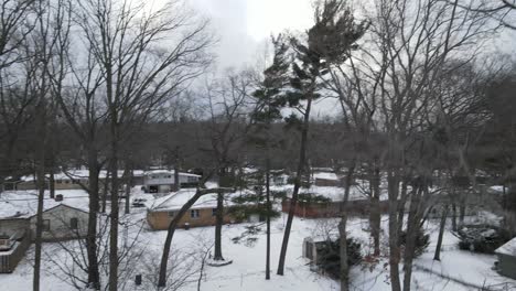 Fast-spin-with-drone-in-winter,-light-snowfall