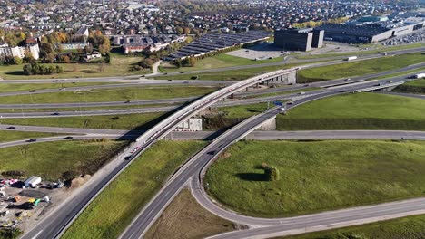 aerial view of a complex highway a5 interchange connecting kaunas city with a1 highway, featuring multiple ramps, overpasses, and surrounding urban and natural landscapes in lithuania