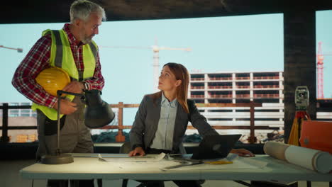 Construction Engineers and Architects Discussing Plans at a Site Office