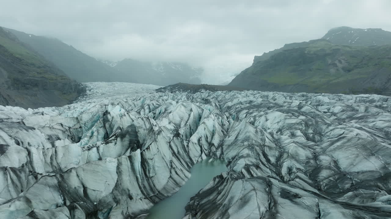 Aerial drone footage of Svínafellsjökull Glacier in Iceland, showcasing its stunning ice formations. Part1.