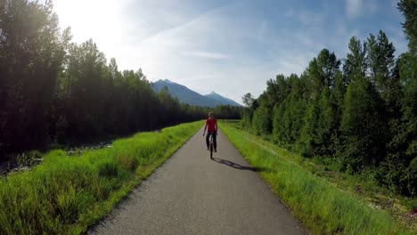 Woman-riding-unicycle-on-countryside-road-4k