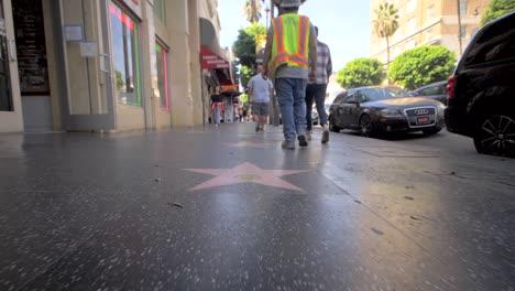 people walking down hollywood walk of fame