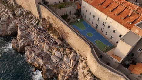 aerial view of dubrovnik old town with coastal restaurant and basketball court