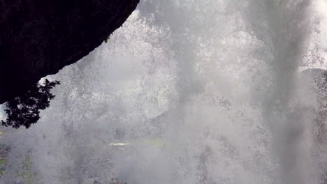 wall of water cascading from behind steinsdalsfossen waterfall in steine, norway, 4k prorezhq
