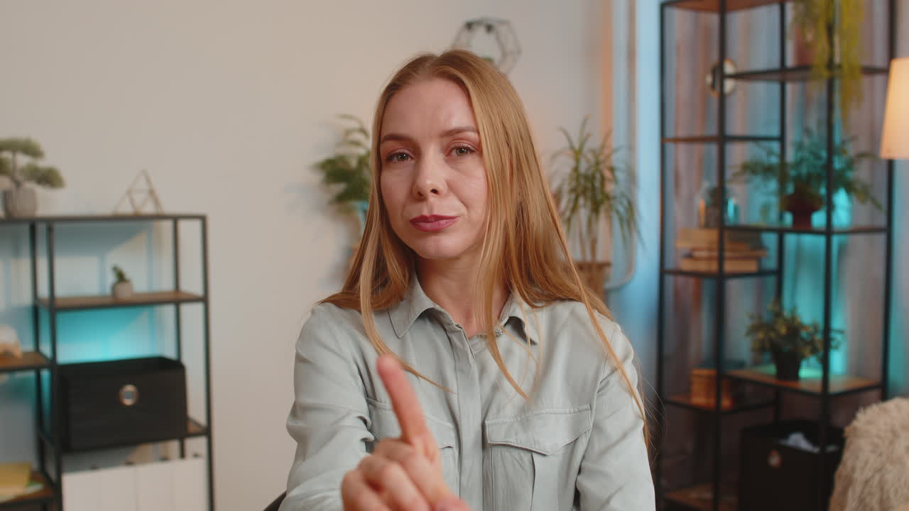 Displeased caucasian woman freelancer shake finger no sitting at home office desk in living room