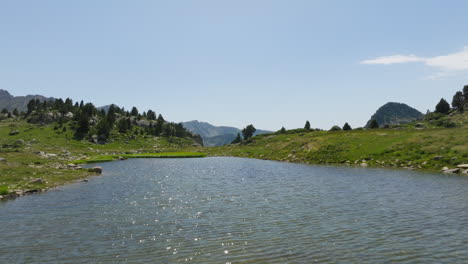 a couple walking by a lake in the mountains of andorra