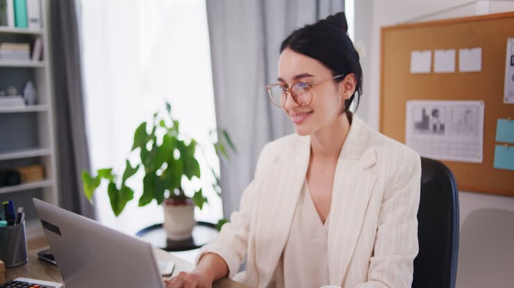 Happy Woman Starts Writing Emails at Desk