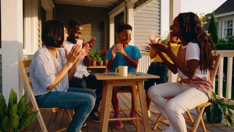 joyful family playing games on the porch