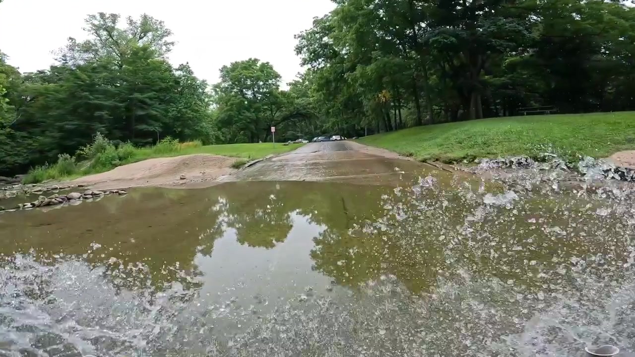 POV - Driving on the park road in Ledges State Park in central Iowa; driving thru a ford where Peas Creek flows over the park road; pedestrian stone bridge over the creek; outdoor adventures