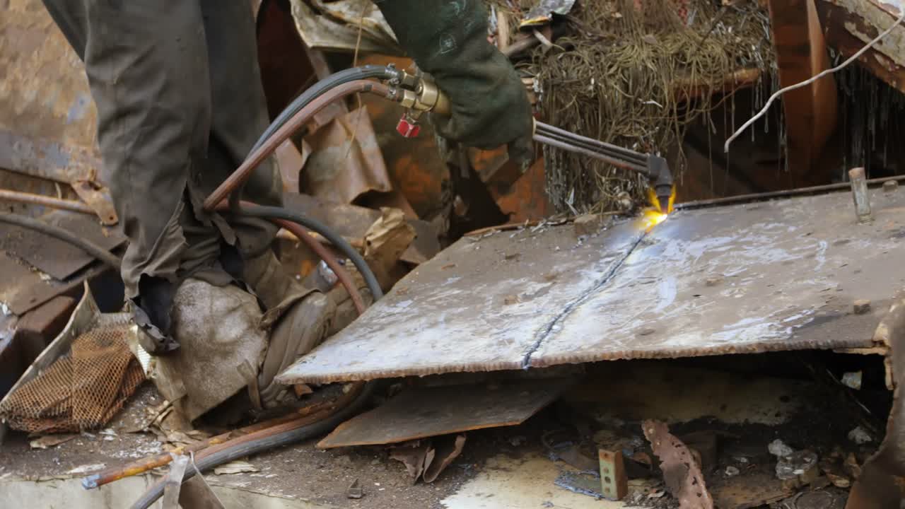 Male worker cutting metal with wielding torch 4k