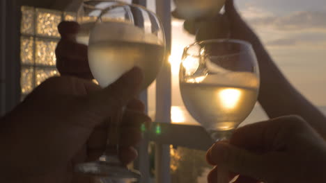 family celebrates raising their glasses of white wine in city perea greece