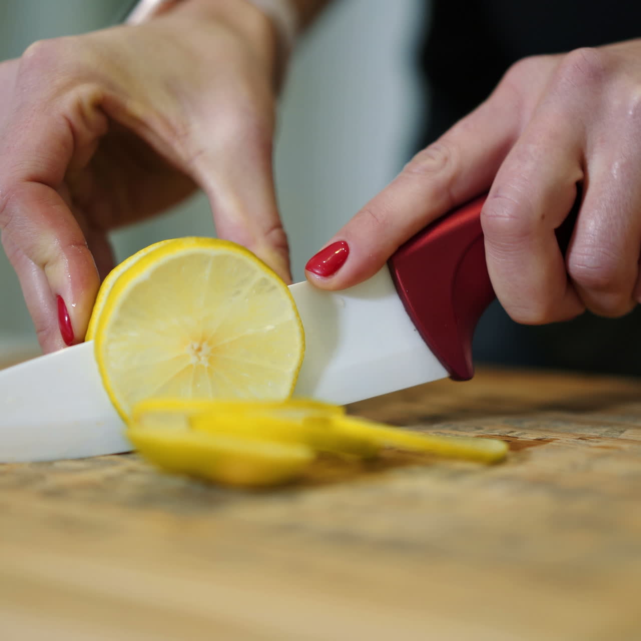 Female hands cutting fresh juicy lemon on a wooden kitchen board. Healthy lifestyle. Fresh fruits. Square video