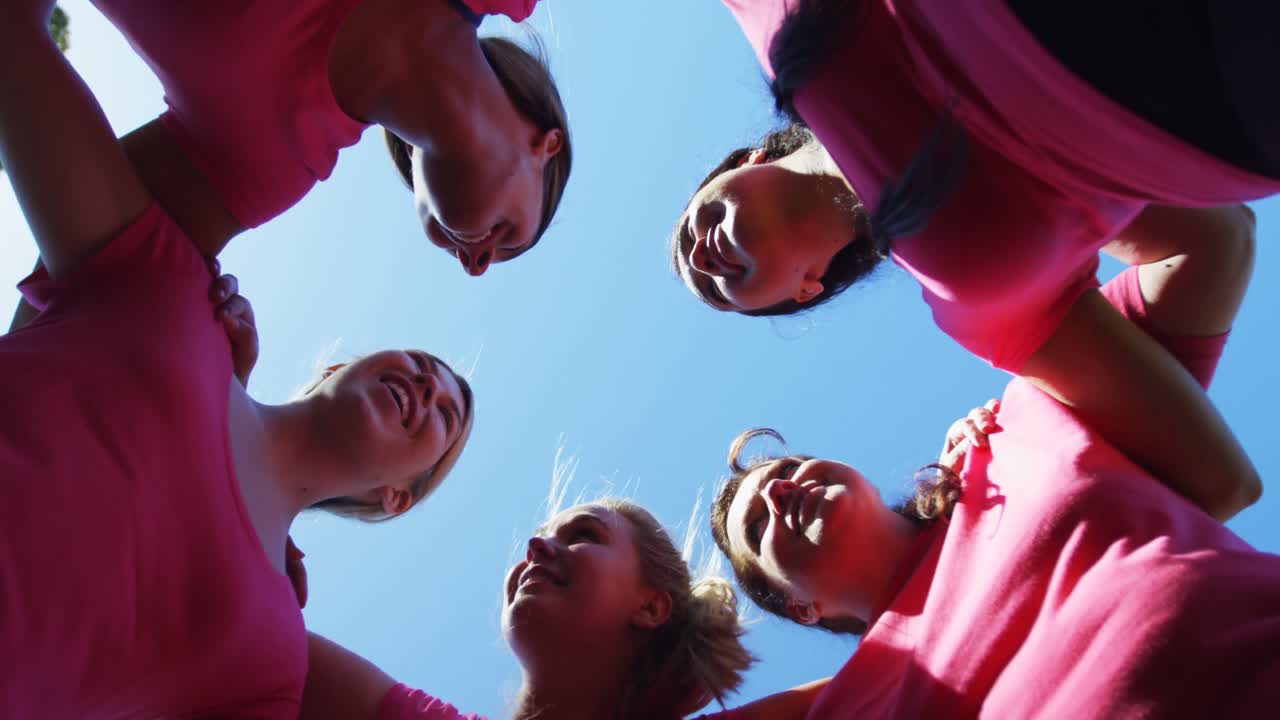 Group of women forming huddles during obstacle course