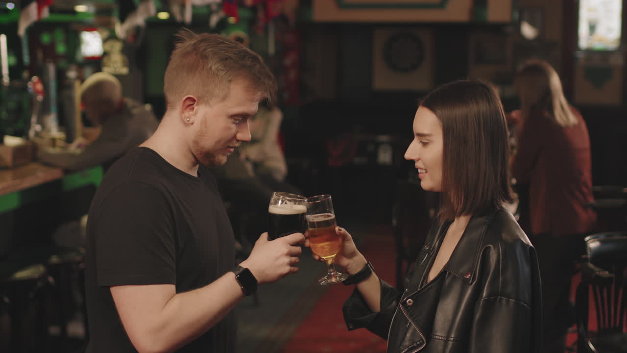 Young Couple Drinking Beer At Pub