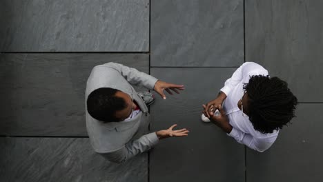 top view of business people shaking hands and talking