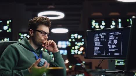 Pondering software developer working computer at server room closeup. IT worker