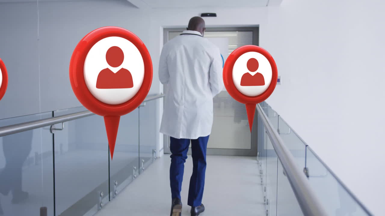 Animation of media icons over african american male doctor walking in hospital