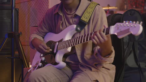 Young-Girl-Playing-Guitar-During-Rehearsal-In-Recording-Studio