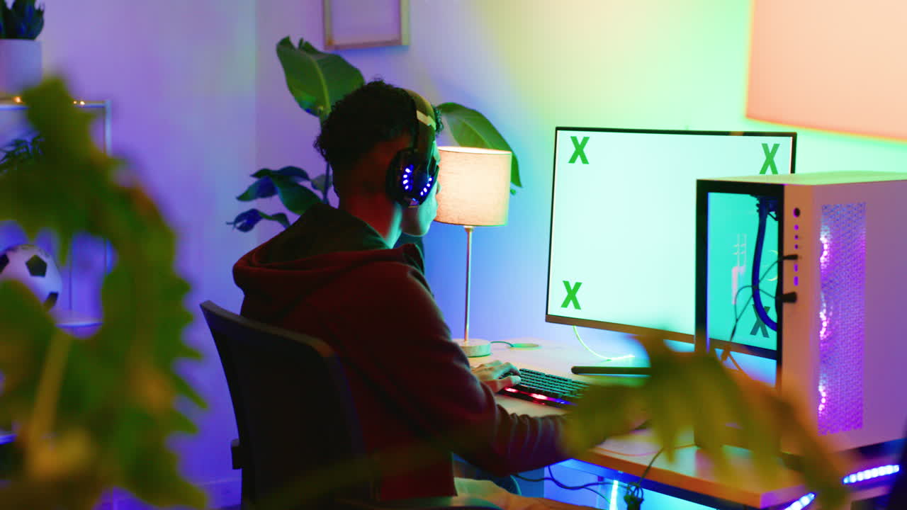 Young guy playing video games on a computer
