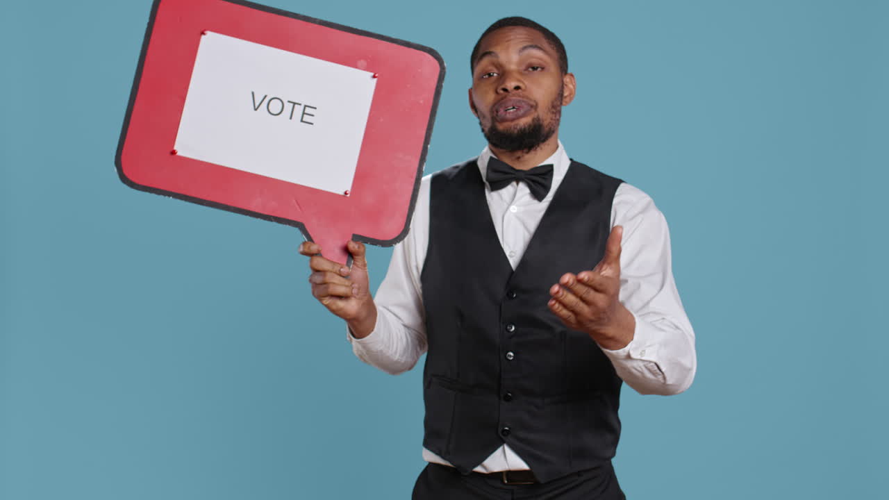 Hospitality industry worker shows speech bubble with political message