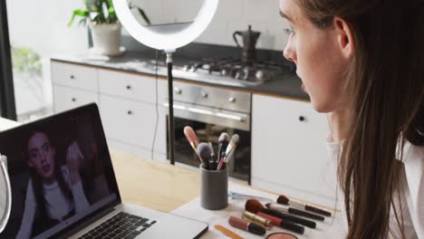 caucasian non-binary transgender woman making make up video