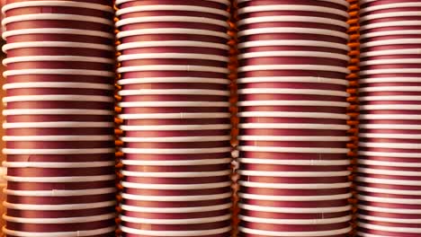 stack of red and white paper coffee cups