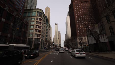 forward street view driving through city skyscrapers tilt up