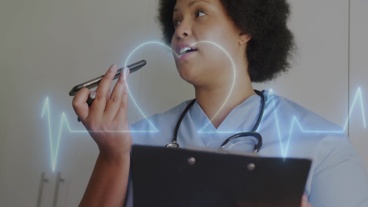 Animation of cardiograph and heart over biracial female nurse talking on smartphone