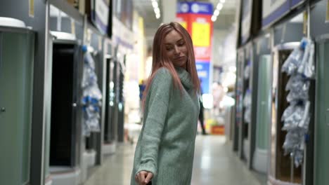 woman dances in hardware store between the rows