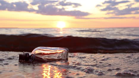 message in the bottle against the sun setting down