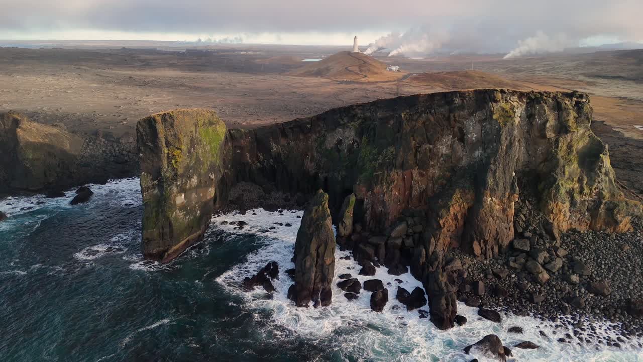 Dramatic Aerial View of Icelandic Coastline with Lighthouse and Geothermal Power Plant