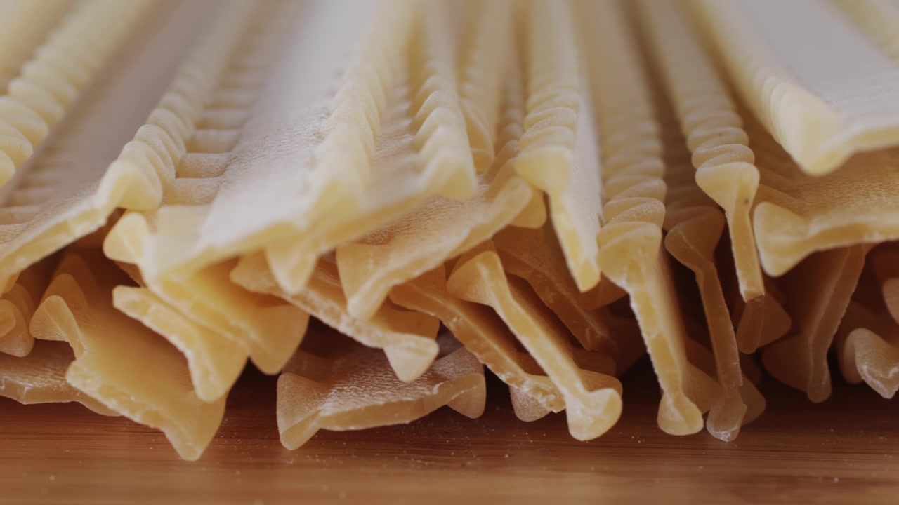 Primo piano di pasta cruda su un tagliere di legno