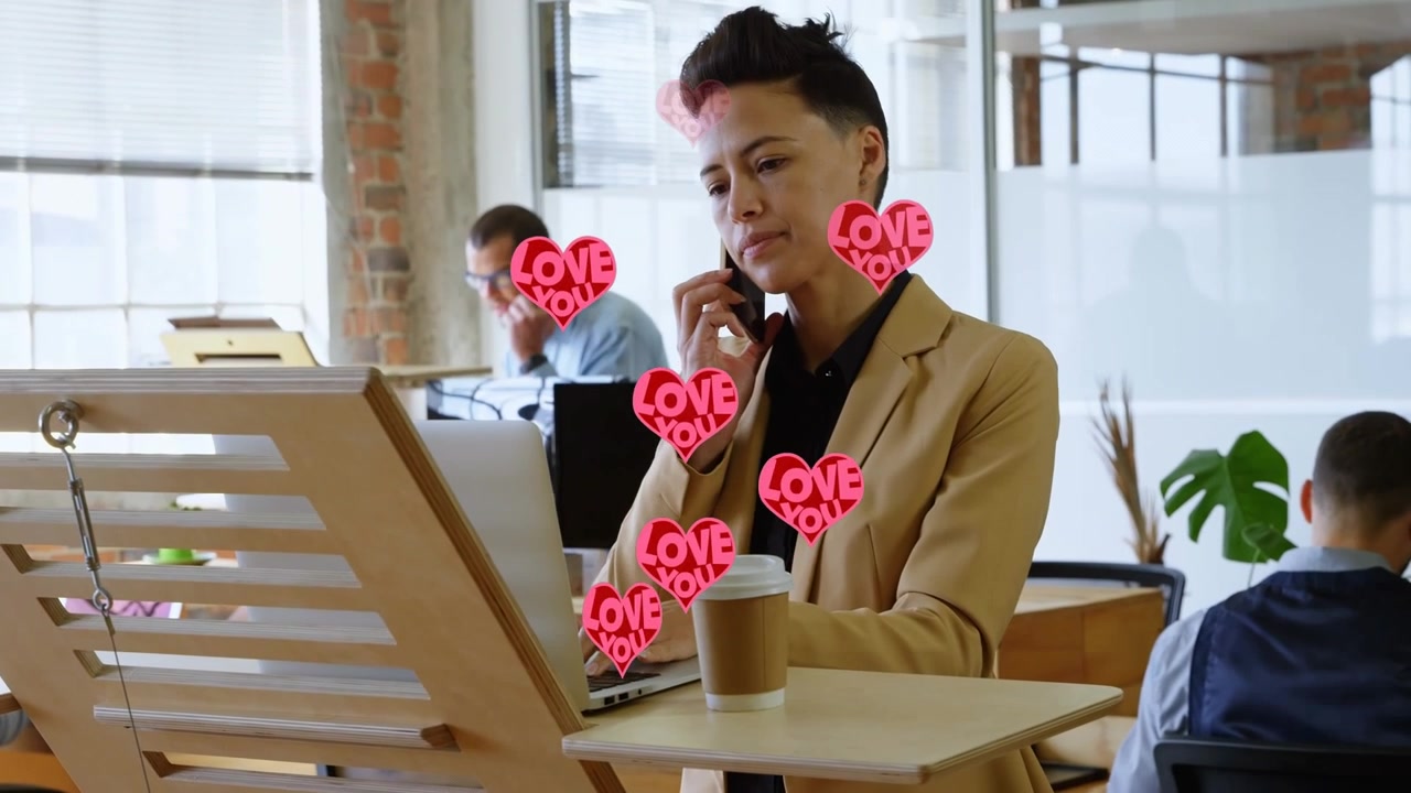 Animation of red hearts over businesswoman using smartphone