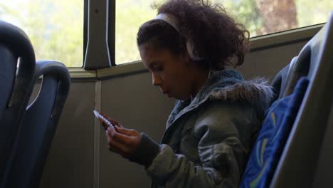 girl listening music on headphones while travelling in bus 4k