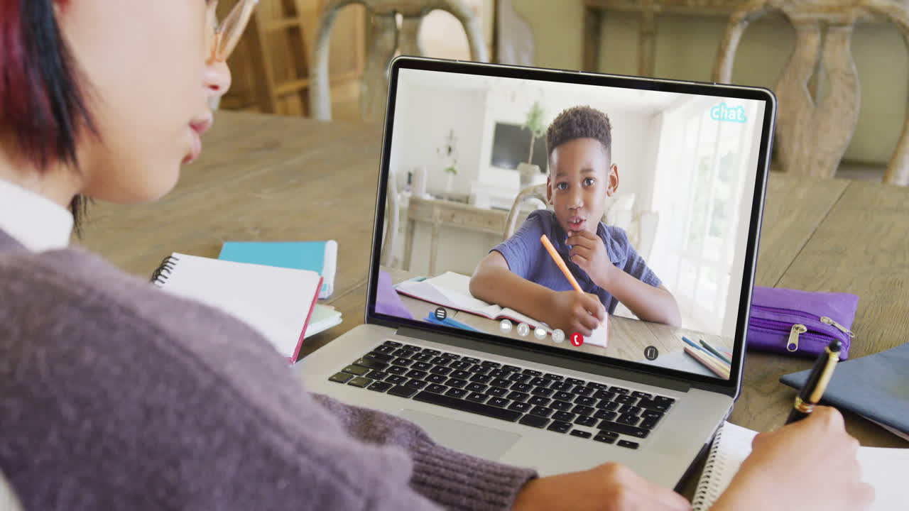 Asian female student using laptop for video call with african american schoolboy on screen