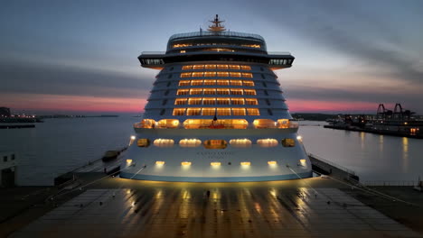 aidacosma cruise ship illuminated at twilight in port